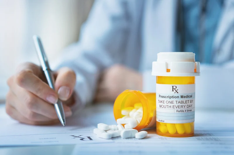 Nephrologist managing anti-rejection medication prescriptions for post-kidney transplant care at Nephrology Associates in the Greater Providence area